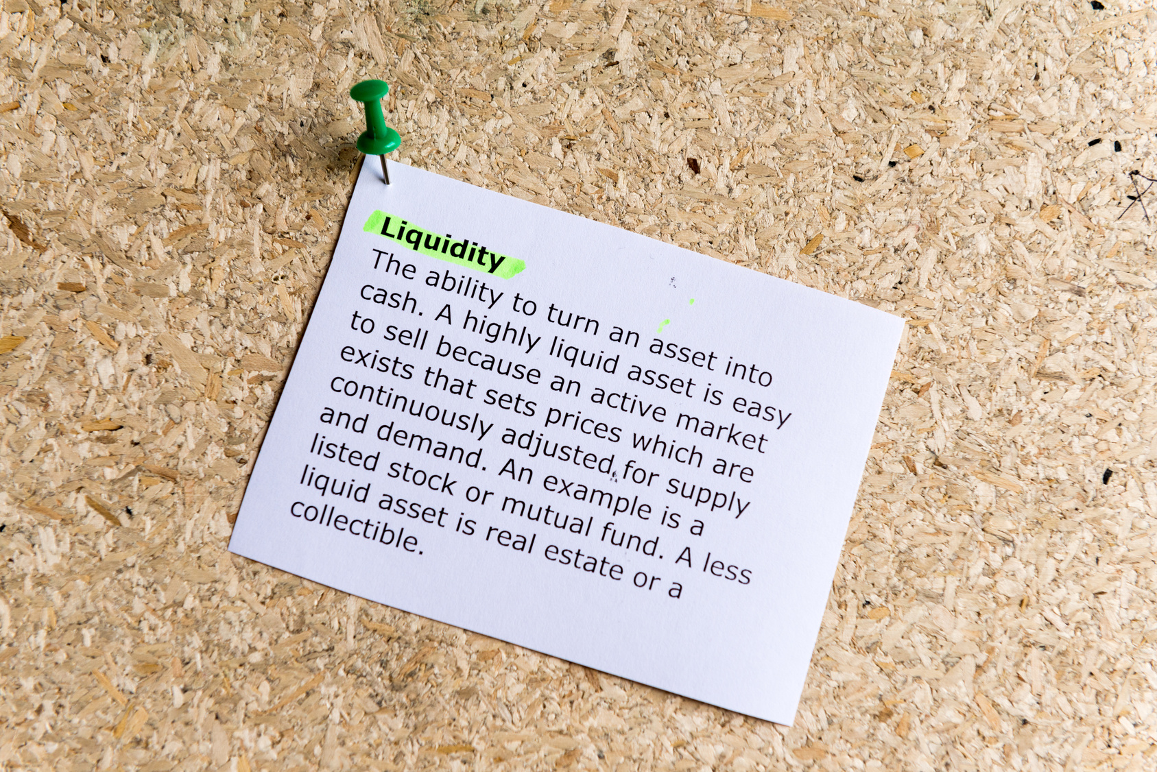 liquidity word typed on a paper and pinned to a cork notice board